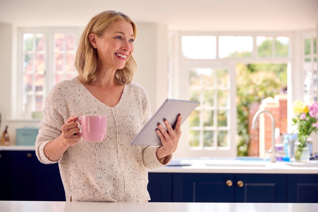 mature-woman-with-using-digital-tablet-at-home-to-2023-11-27-05-24-02-utc